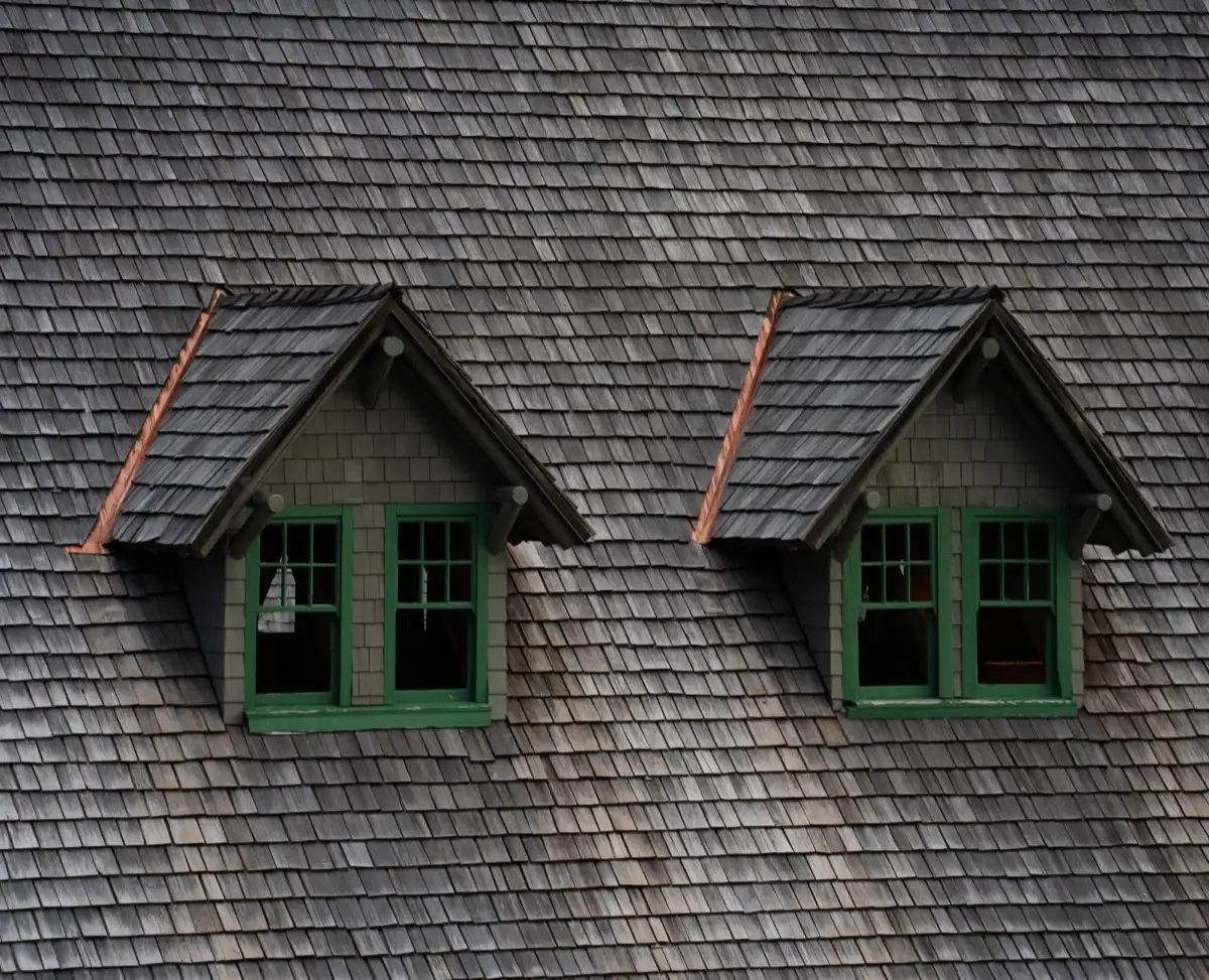 Dormers on a shingle roof in Orland Park, IL, where step flashing and kickout flashing carry water past the walls